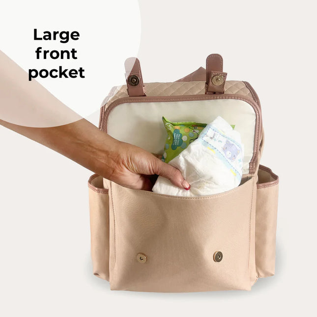 Front pouch of changing backpack is open showing it holding nappy wipes and nappies.