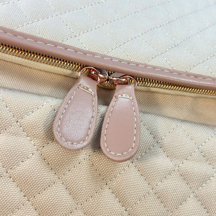 A close up image of the changing bag zip with two leather tags.