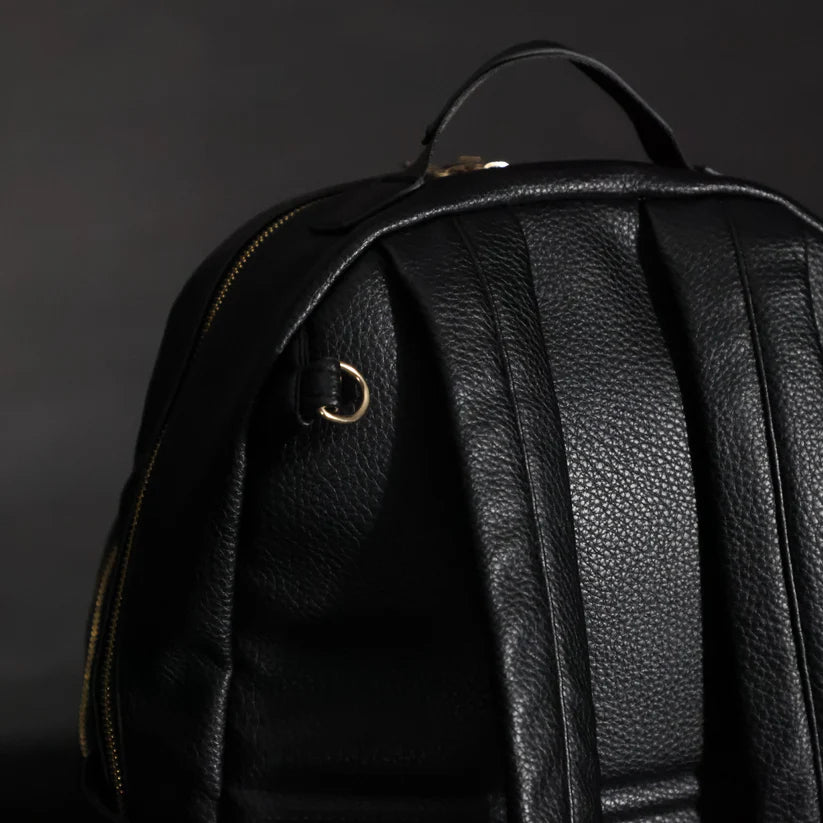 The back of the Changing Backpack showing where the stroller clips attach to and the grab handle.