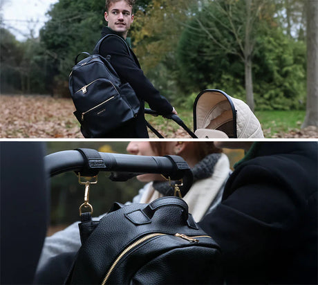 Man pushing a stroller with a black backpack, surrounded by greenery with a close up of the backpack hanging on the back of a stroller using stroller clips.