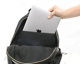 Person placing a laptop into a black changing backpack.