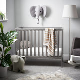 Bantam Space Saver Cot in Taupe Grey shown in a Baby's Nursery